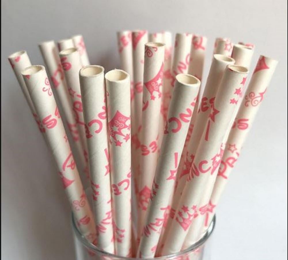 White paper straws with pink designs in a glass container on a gray background