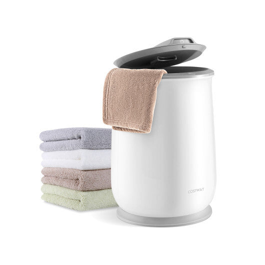 White laundry basket with a towel on top next to folded towels on a white background