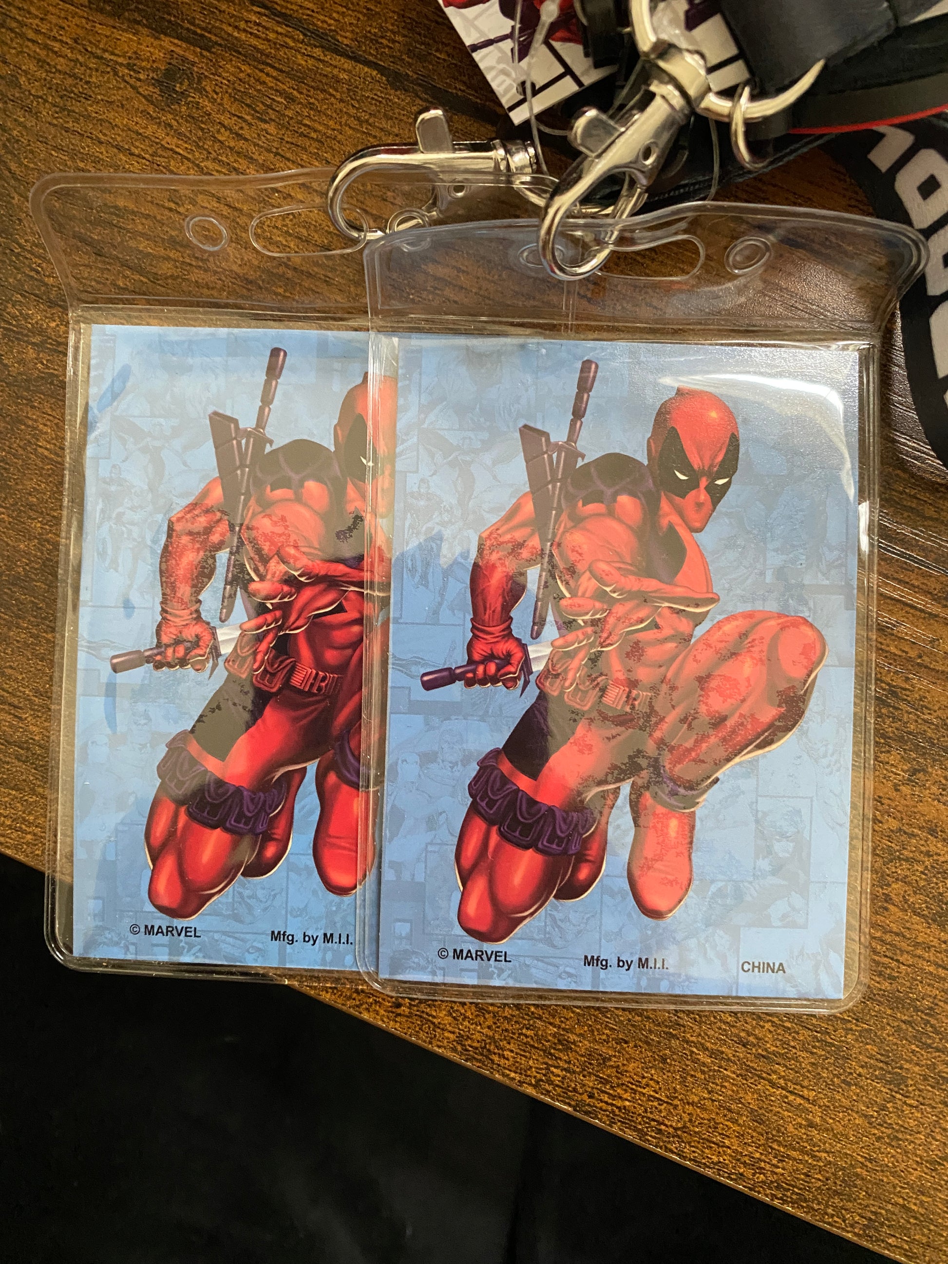 Deadpool trading card in a clear holder on a wooden surface
