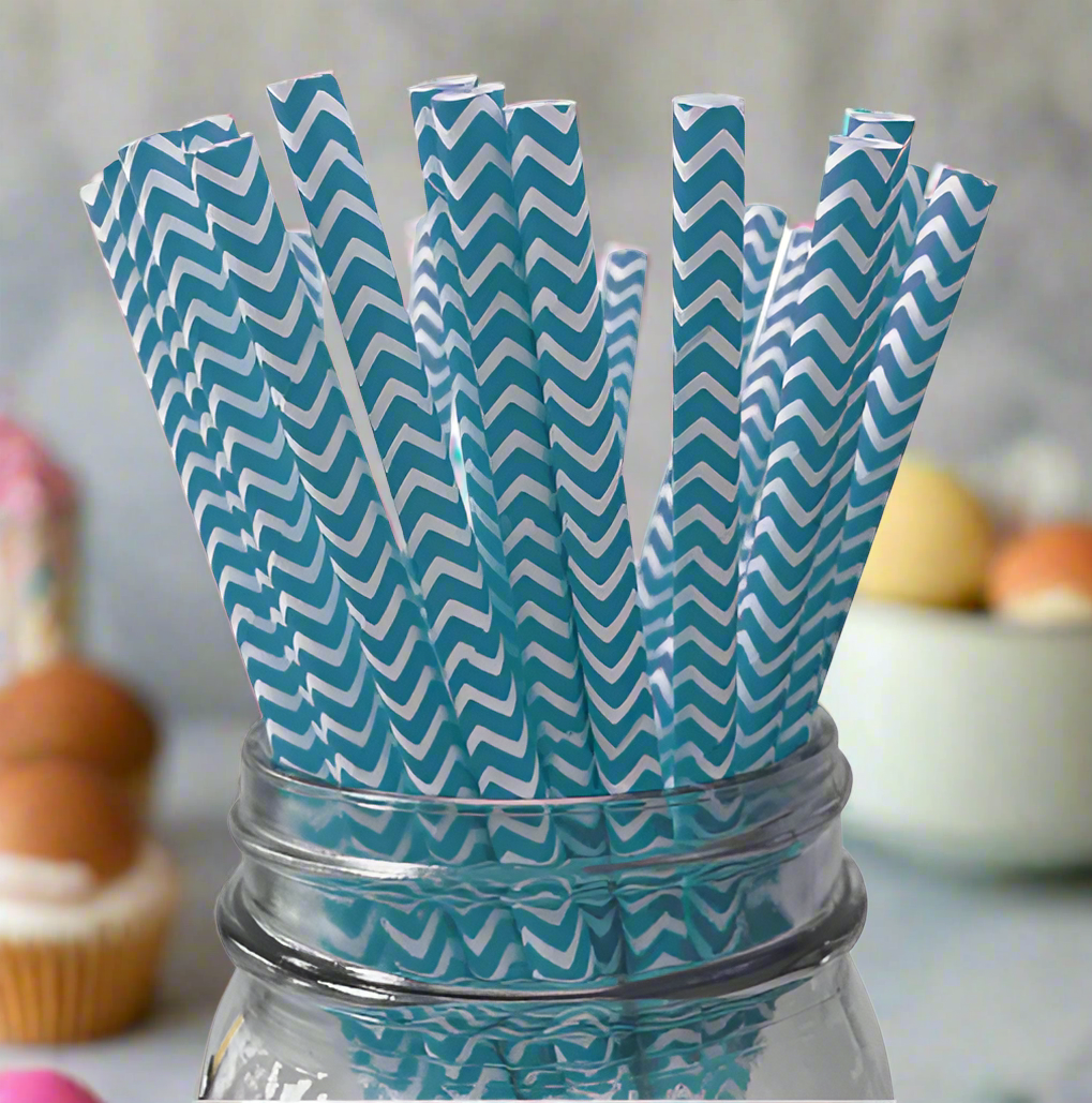 Blue and white chevron-patterned straws in a glass jar on a white background
