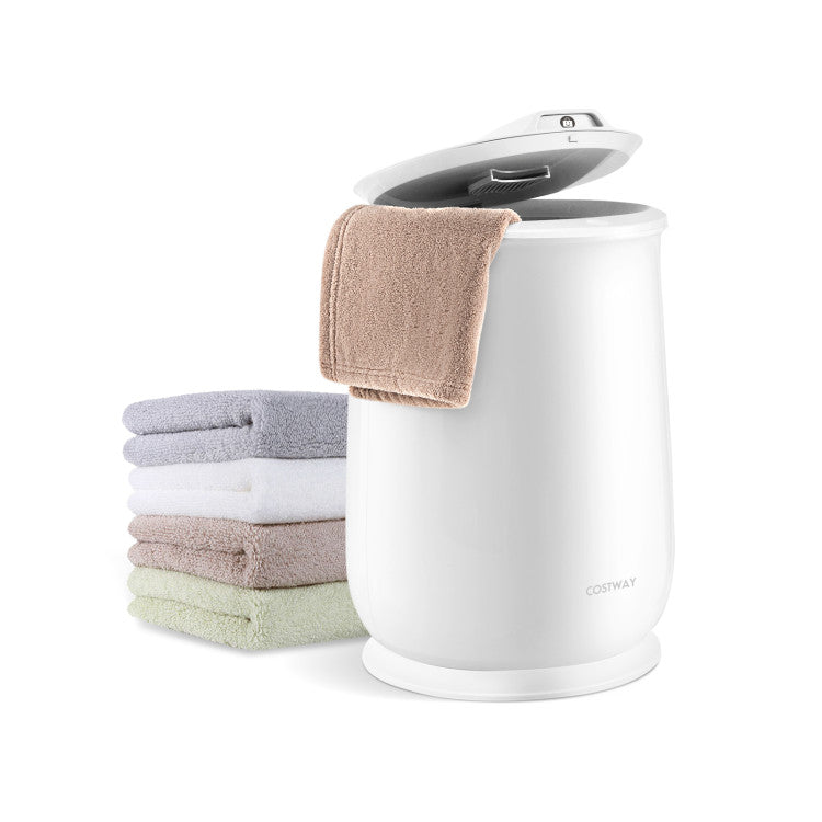White compact washing machine with folded towels on a white background